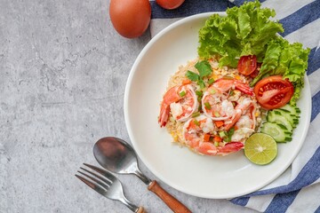 Fried rice with shrimps on a white plate, top view table	