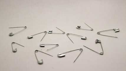 Fototapeta premium The safety pin is made of metal and silver in color.