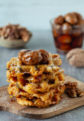 Homemade rustic pumpkin waffles with honey and walnuts  topping 