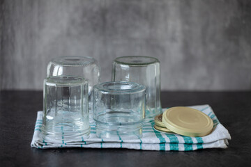 Sterilised preserving jars on a tea towel, recycled dishes