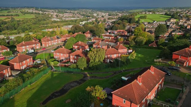Yorkshire's urban community: Red brick council estate, aerial drone shot, sunny morning, people walking