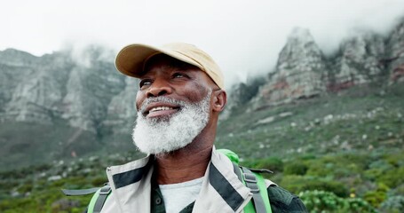 Senior man, backpack and hiking in mountains with trekking, adventure and happy from view in nature. Outdoor, camping and travel with retirement vacation and African person with smile and calm