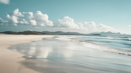 Obraz premium A pristine, deserted beach with soft white sand and gentle waves lapping at the shore