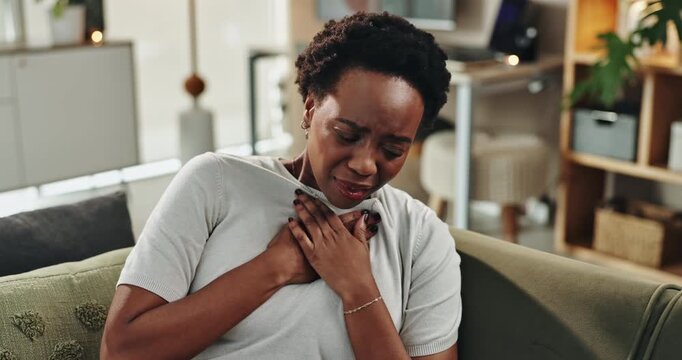 Home, sick and black woman with chest pain, emergency and asthma on sofa in living room. Breathing problem, medical heart attack and person panic with stress, tuberculosis and massage muscle strain