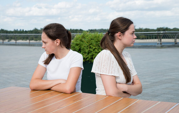 The girls look in different directions with resentment