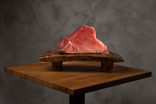 Fresh tuna steak on wooden cutting board