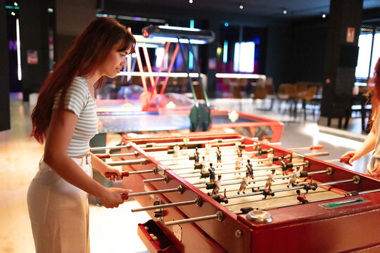 Woman playing foosball in an entertainment club
