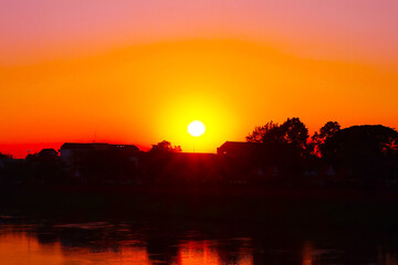 Sunset in the evening, golden light shines through the Nan River in the center of Phitsanulok, northern Thailand, Southeast Asia.