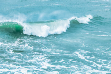 Wave splashing close-up. Crystal clear sea water, in the ocean in San Francisco Bay, blue water, pastel colors.