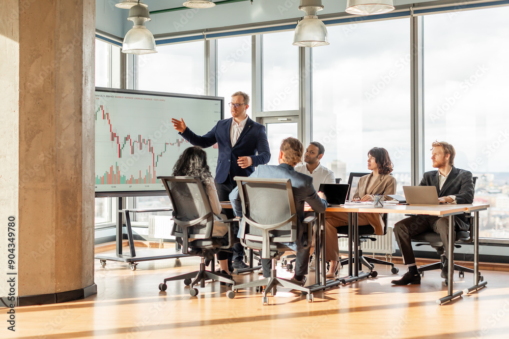 Poster a group of people is sitting around a table in a modern office, listening to a presentation on a lar