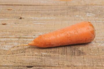 A Fresh Organic Carrot Placed Beautifully on a Rustic Wooden Surface for Presentation