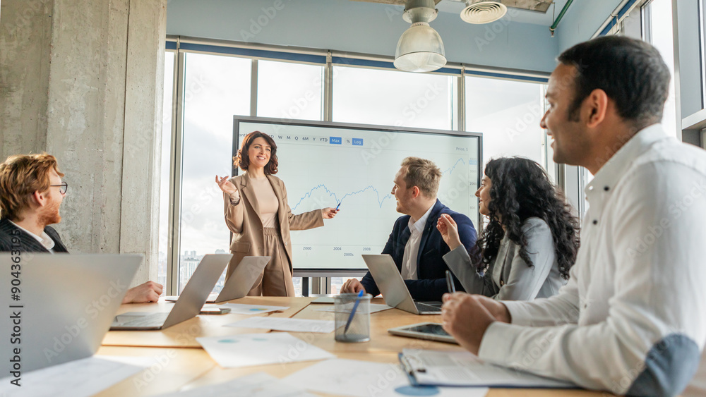Poster a businesswoman, standing in front of a whiteboard with a graph displayed, gestures towards the data