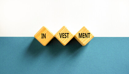 Investment symbol. Concept word Investment on beautiful wooden blocks. Beautiful blue and white background. Business investment concept. Copy space.