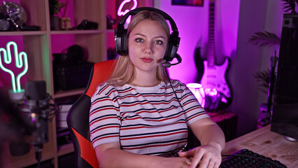 Young woman with headset gaming in a neon-lit room at night, conveying tech, leisure, and lifestyle.