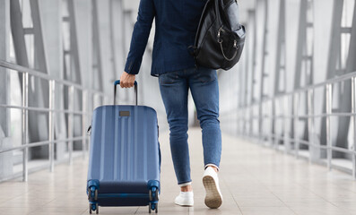 Unrecognizable Man With Bag And Suitcase Walking In Airport Terminal, Rear View Of Young Male On...
