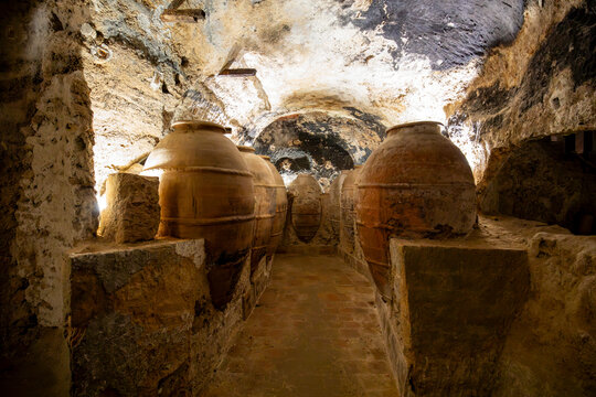 Huge clay jars in one of the caves of the town of Requena, Valencia, for food storage with artificial light