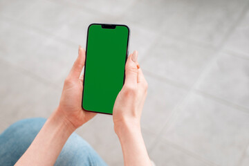 Person Holding Smartphone With Blank Screen In Indoor Setting During Daytime