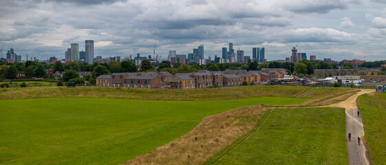 Obraz premium Aerial view of a suburban residential area with a Manchester city skyline in the background.