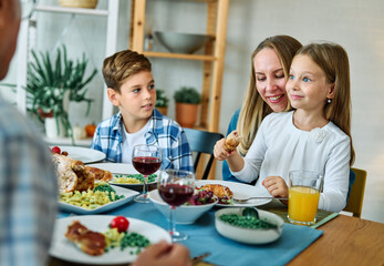 child family lunch food meal eating mother dinner father together happy daughter son boy girl home table parent