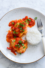 Baked cod fish in tomato and pepper sauce