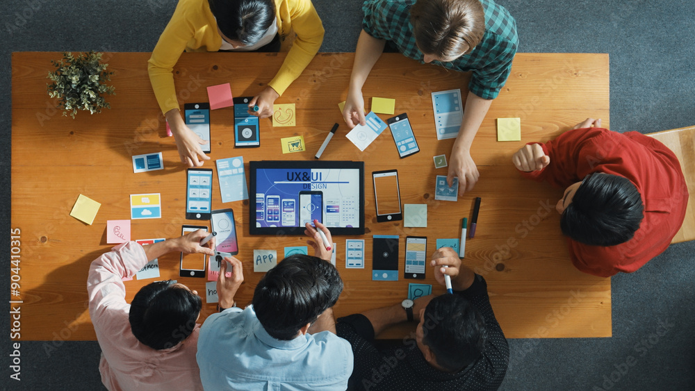 Fototapete top down view of business team writing idea on sticky note while planing for ux ui design for mobile