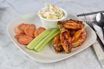 chicken wings  with carrots and celery