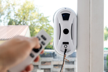 Remote control of a robotic window washer that washes glass from dirt and stains.