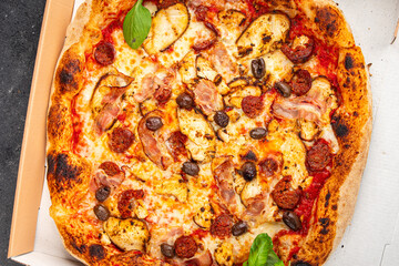 pizza chicken meat, sausages, olives, cheese, tomato sauce.fresh meal food snack on the table copy space food background rustic top view