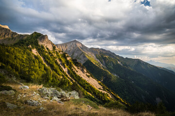 View on the mountains at evenign in summer with grey clouds in the sky