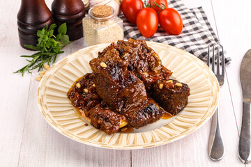 Prepared tasty beef ribs with sauce