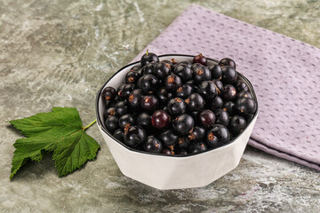 Ripe black currant in the bowl