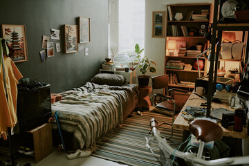 Male dorm room made in pastel colors and decorated with posters fully equipped with gadgets and personal items