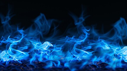 Closeup of bright blue flames exhibiting intricate textures with an intense display of color isolated on a dark backdrop