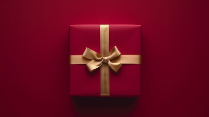 A vibrant red gift box adorned with a shiny gold ribbon is prominently featured against a clear background, highlighting its festive appeal for special events