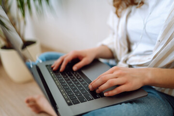 Fototapeta premium Female hands typing on laptop keyboard close up. Copywriter writing text. Business, Freelance, Shopping, education. Online.