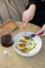 Delicious appetizing Ukrainian food and female hands with utensils