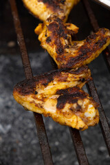 Chicken wings are nicely fried on the coals of the barbecue
