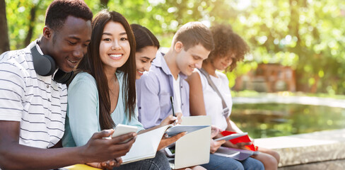 Outdoor Portrait Of Happy International Students Stydying Together In Park, Preparing For Lessons, Asian Girl Looking At Camera, Closeup