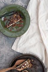 Dark chocolate brownie crusted cheesecake topped with caramel, chocolate, chocolate chips and walnuts.