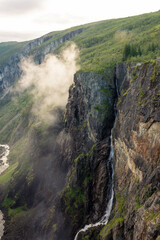 Beautiful view over the misty cliffs of the Voringfossen waterfall,  Norway