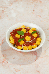 Gnocchi with tomato sauce, basil, cheese. italian dish, homemade food, pasta.