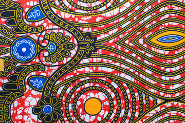 top view of orange ankara fabric, flatlay of nigerian wax cloth with designs, spread out orange ankara material