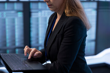 Software developer in data center checking rigs and hardware, doing checkup. Close up of employee...