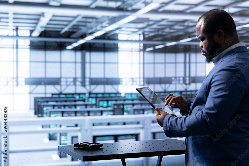 Poster engineer in data center using tablet to identify and solve technical issues related to data center i