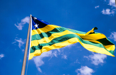 Goiás State Flag. The yellow represents the gold, the green represents the forests, and the five white stars in the upper left hoist represent the Southern Cross. Goiania, GO, Brazil, 2020