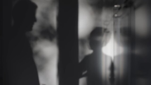 Shadow play of boy reflected on gray wall light and shadow games featuring boy form on wall. Gray wall with boy shadow creating unique visual light and shadow play boy silhouette standing out