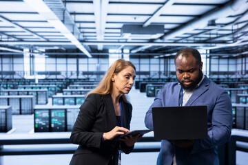 Team of programmers in data center checking rigs and hardware, doing checkup. Teamworking...
