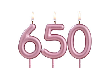 Candle number 650 - Lit birthday candle on white background