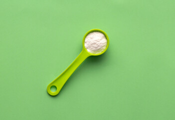 Baking soda in the spoon - Healthy food. Green background