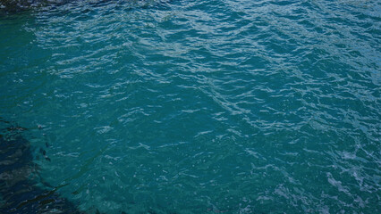 Crystal clear blue sea waters ripple gently in torre dell'orso, salento, puglia, italy, showcasing the serene and idyllic beauty of the european coastal landscape.
